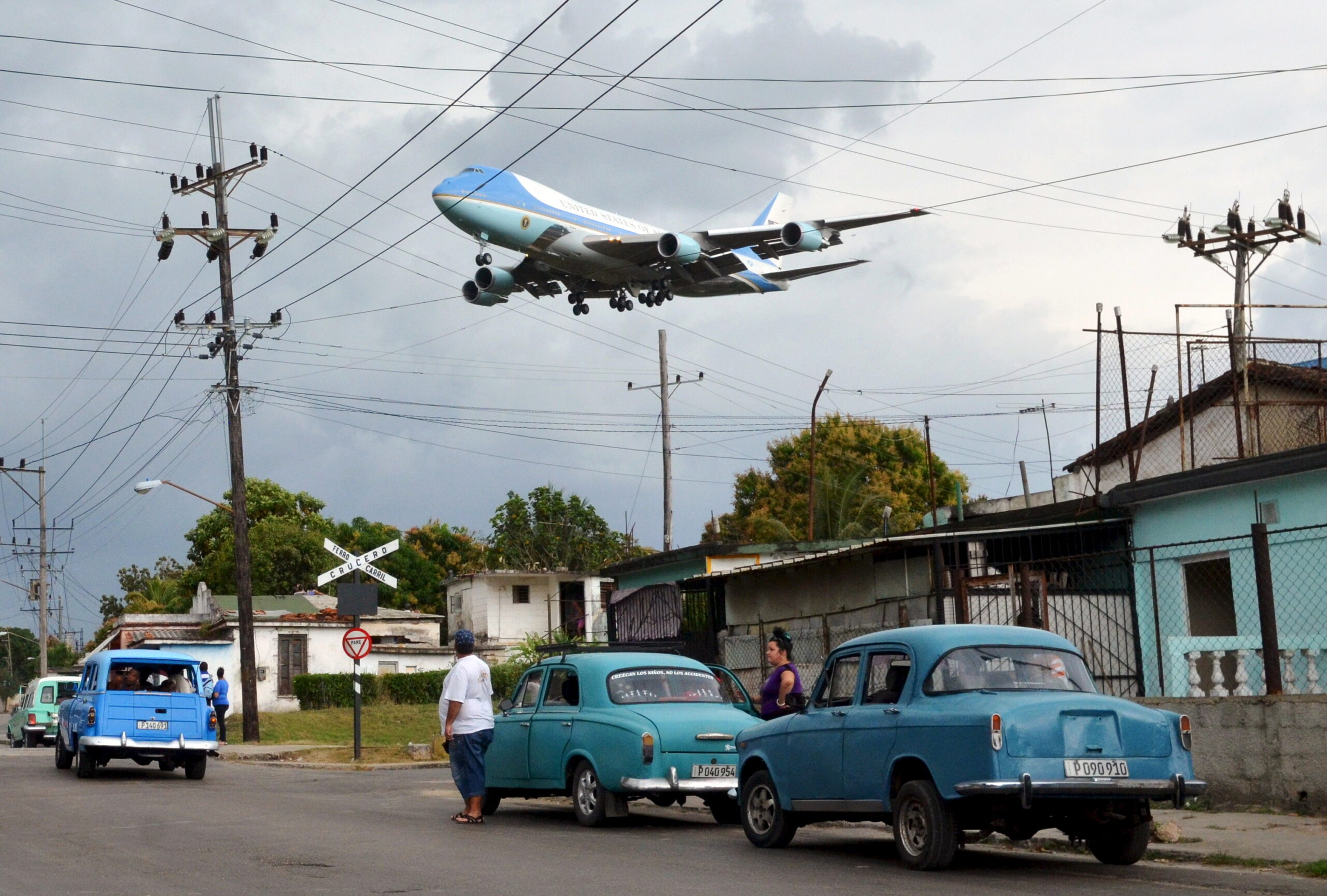 An aeroplane flies low over Havana, Cuba.