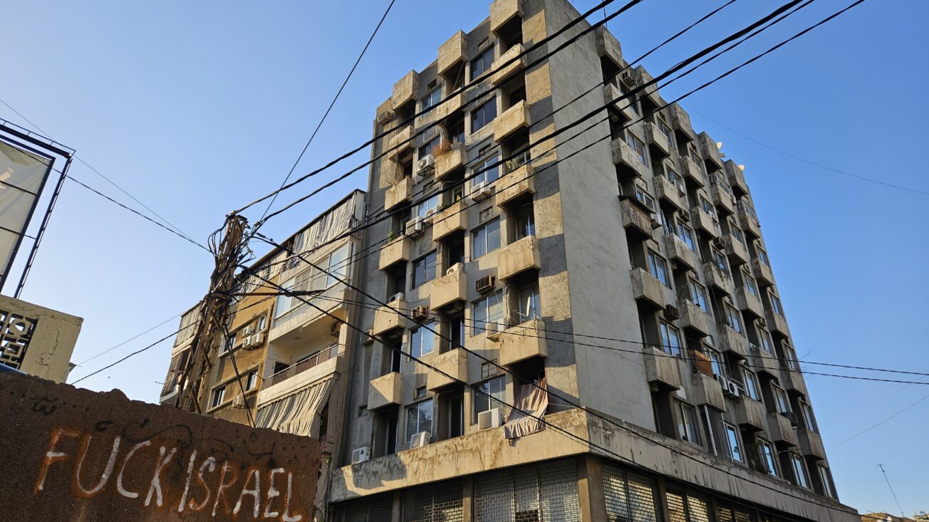 A tower block in Beirut with graffiti that reads 'fuck Israel'.