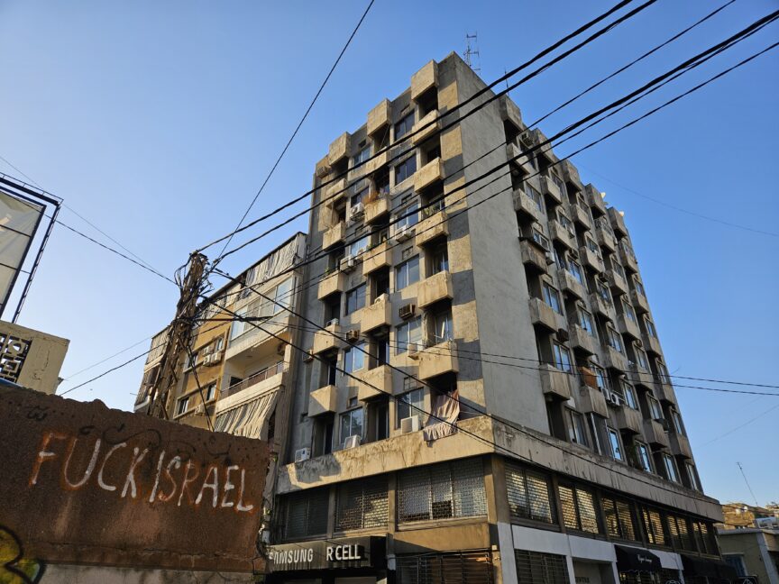 A tower block in Beirut with graffiti that reads 'fuck Israel'.