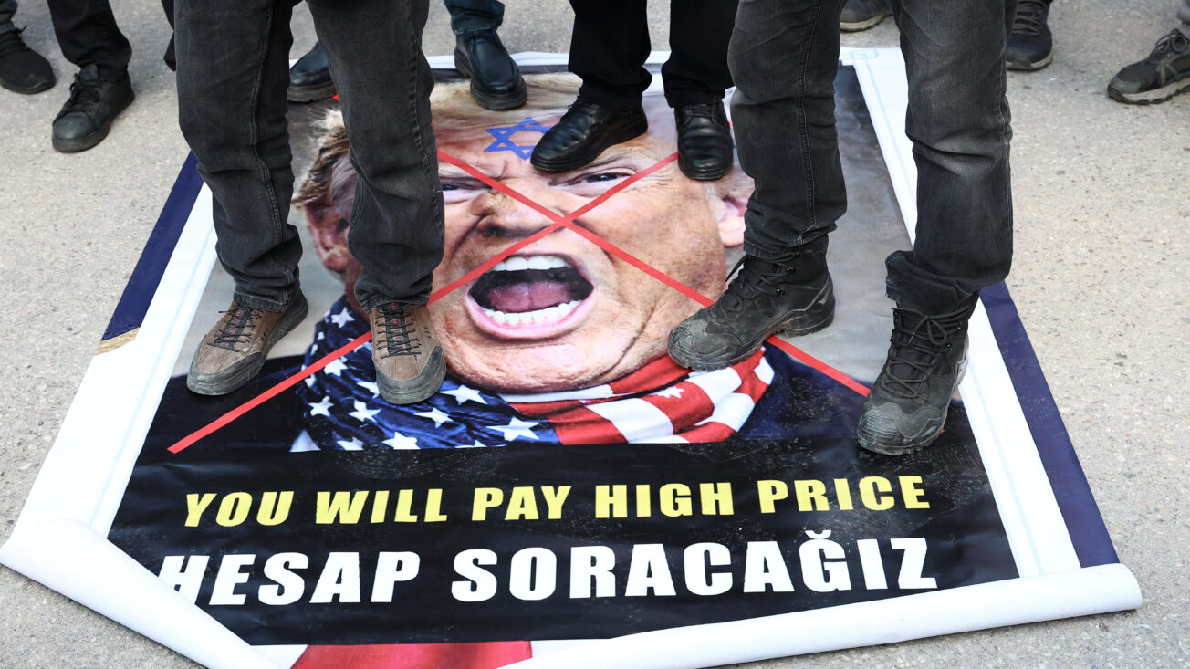 Demonstrators step on a poster of US president Donald Trump during a protest against Israel and the US’s strikes on Iran, following the killing of late Iran’s supreme leader Ayatollah Ali Khamenei, outside the US embassy in Ankara, Turkey, 1 March 2026. Reuters/Efekan Akyuz
