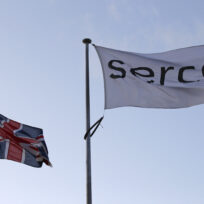 Two flags, one union jack, one says "Serco".