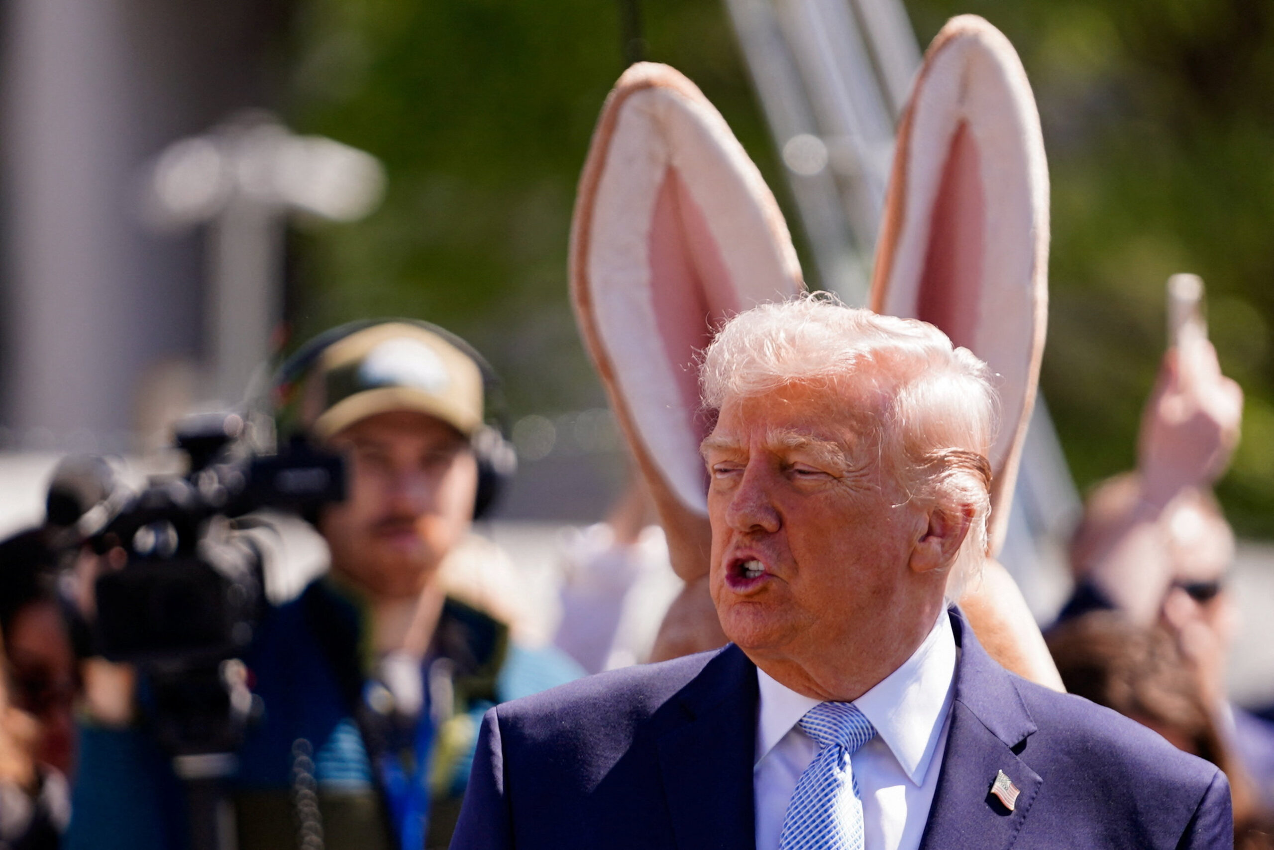 Donald Trump with rabbit ears behind him
