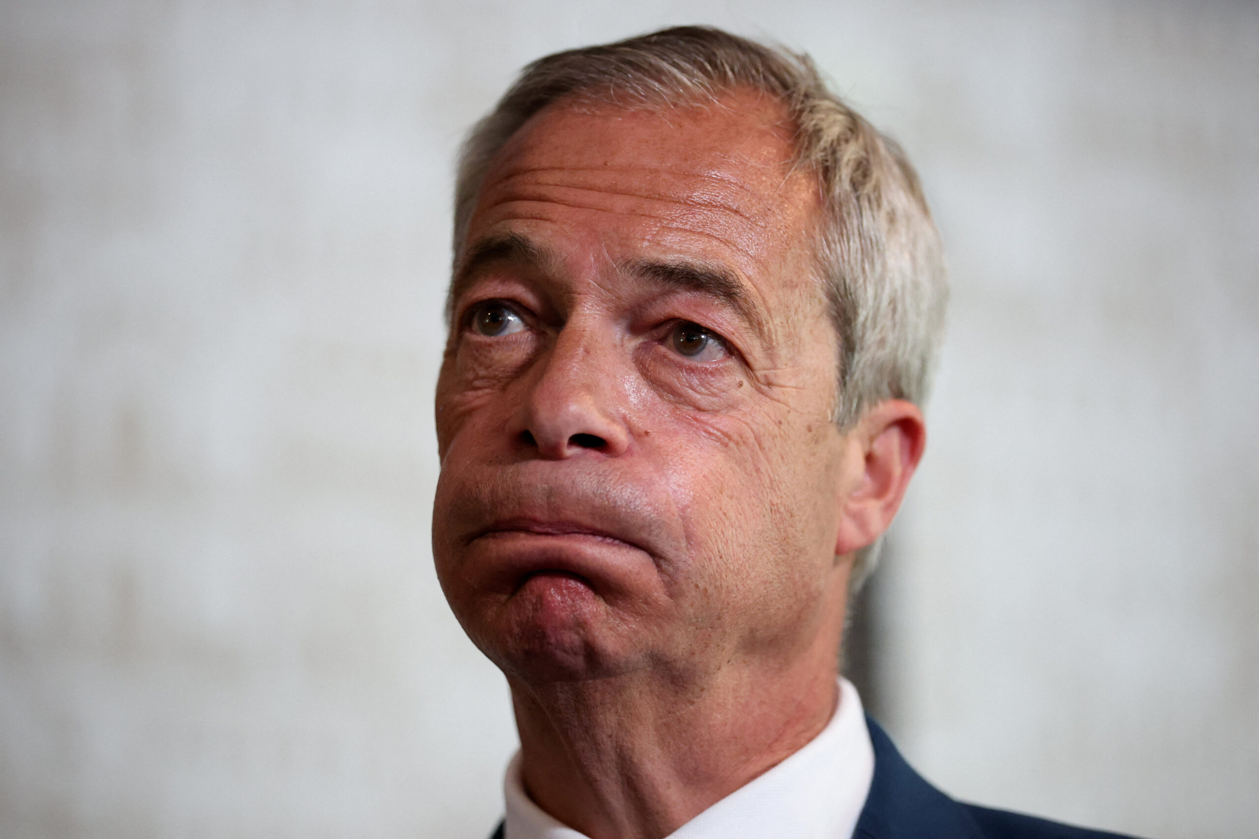 Nigel Farage looks on as he meets with newly elected Reform UK candidates at a bar in St Helens, Merseyside. Photo: Reuters/Phil Noble