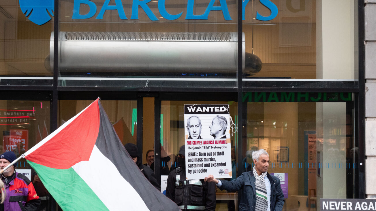 Palestine Solidarity Campaign activists protest outside of a branch of Barclays Bank in Glasgow in December 2025. Photo: Cameron Scott/ZUMA Press Wire