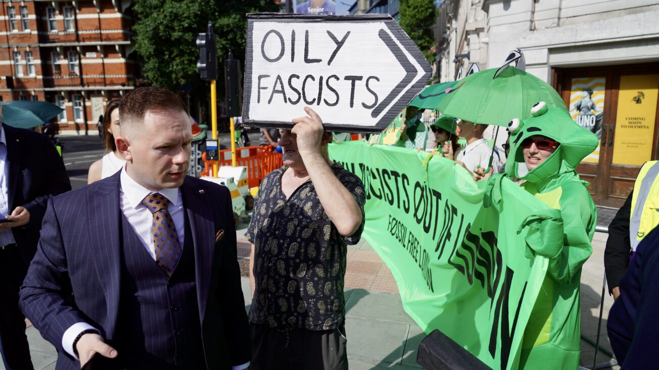 An attendee at the Arc conference makes his way through environmental protesters. Photo: Fossil Free London