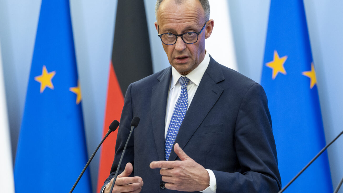 German chancellor Friedrich Merz in front of flags