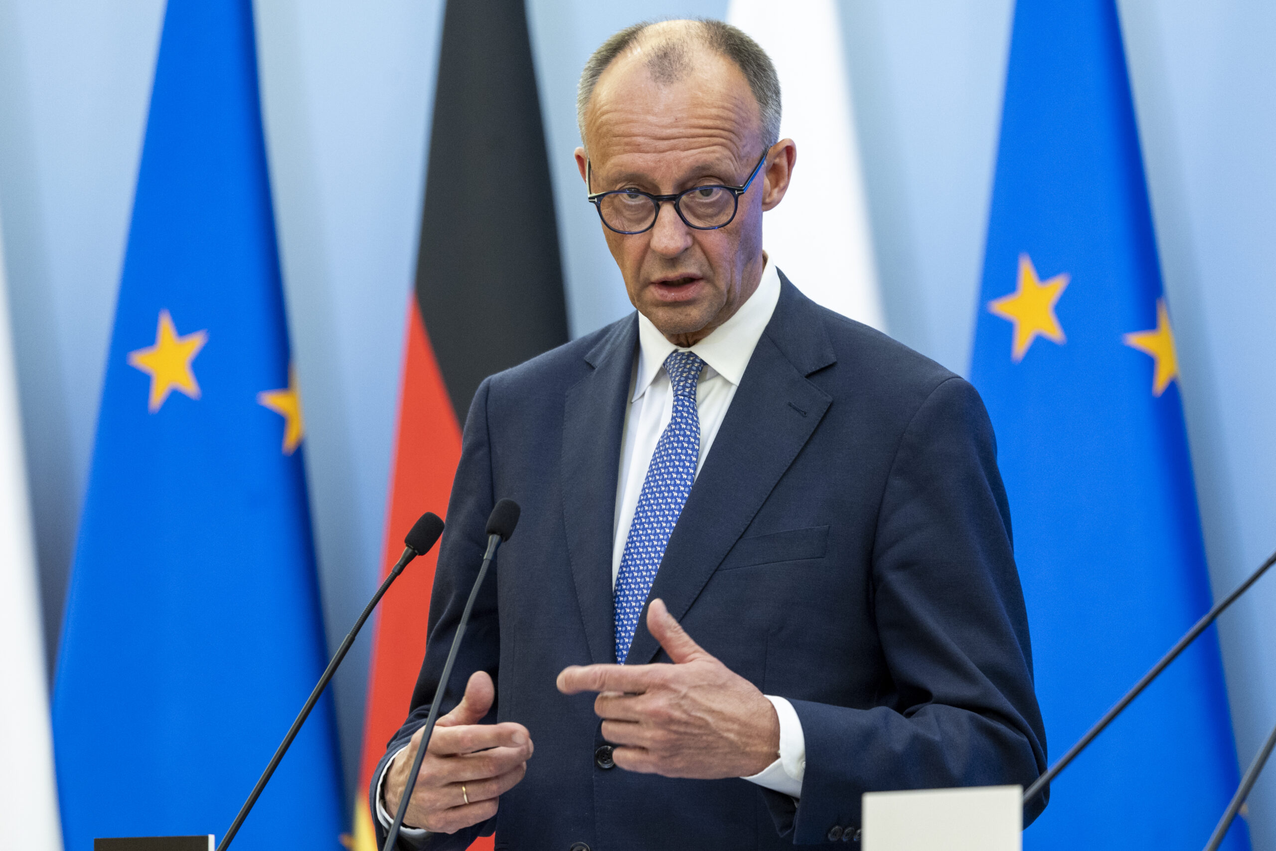 German chancellor Friedrich Merz in front of flags