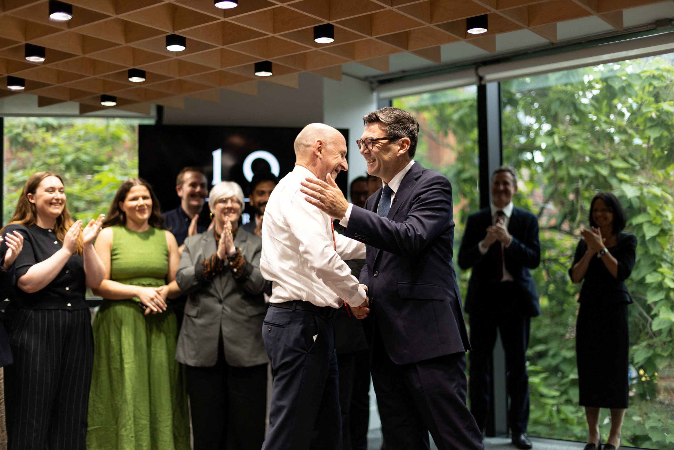 two white men shake hands