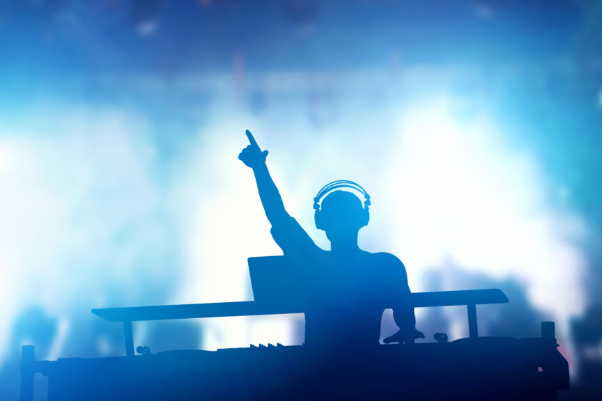 Club, disco DJ playing and mixing music for people.