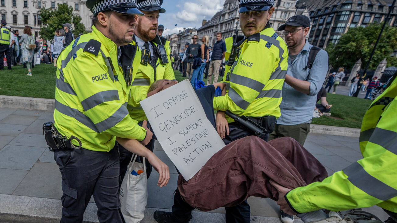 police carry a protester away